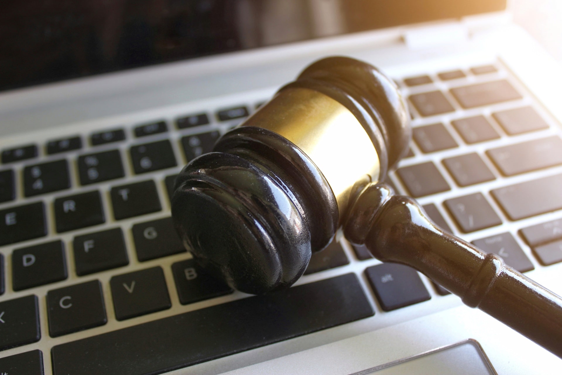 selective-focus-image-of-judge-gavel-and-keyboard-2023-11-27-05-01-24-utc-min